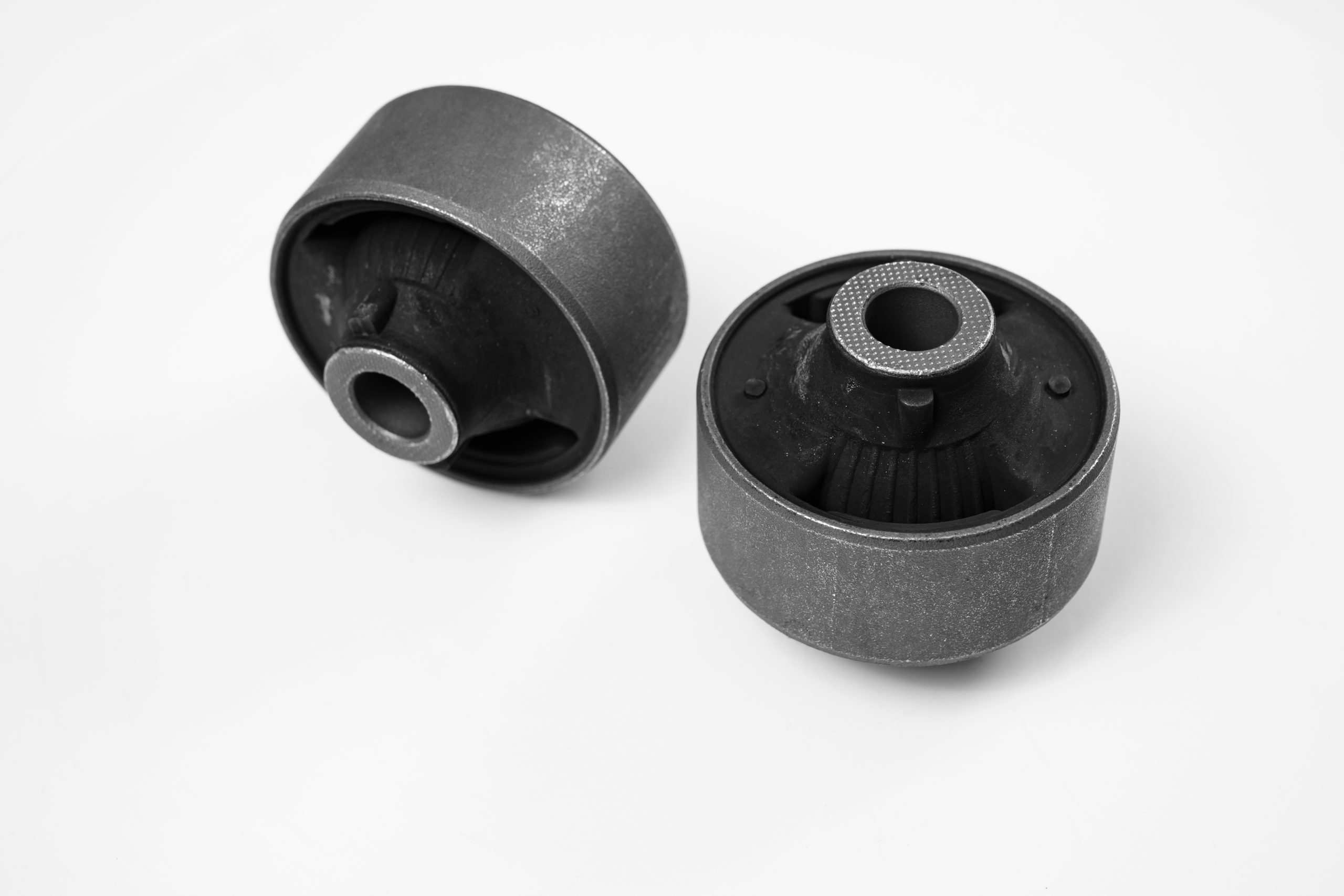 rubber-to-metal-bonding lever silent block against a white background. rubber metal hinge, the elastic part is connected to the inner and outer bonds by vulcanization when manufactured or by glue. Car parts store.