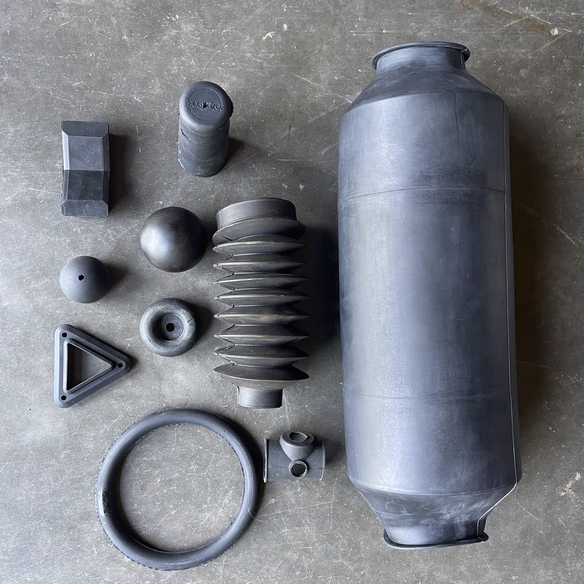 Custom Molded Rubber Parts – CMDI Assorted custom rubber components for industrial and manufacturing use